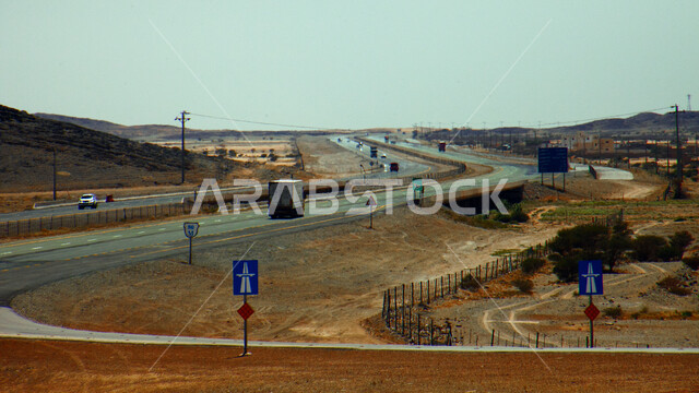 طريق سفر اسفلتي بين الكثبان الرملية، خط سير سريع وسط الصحراء في المملكة العربية السعودية، تهيئة البنية التحتية لشوارع السفر في الطبيعة الصحراوية