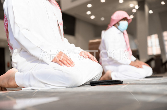 Performing the obligatory prayer inside the mosque, the congregation prayed for two Saudi men wearing the muzzle, keeping the distance between them, adhering to preventive measures, worshiping and getting close to God