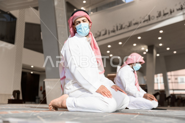 Performing the obligatory prayer inside the mosque, the congregation prayed for two Saudi men wearing the muzzle, keeping the distance between them, adhering to preventive measures, worshiping and getting close to God