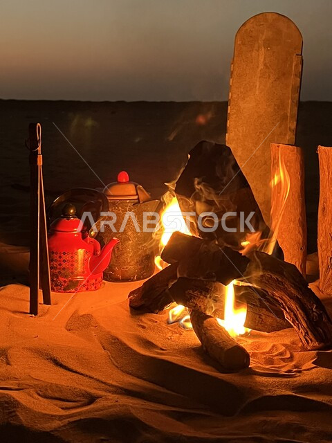 Kashta bar in the desert of the city of Riyadh in the Kingdom of Saudi Arabia, sitting in the middle of the sand at night in the winter, preparing hot drinks on a wood stove, enjoying the quiet atmosphere and having a good time.
