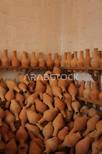 Crafts and handicrafts in the Kingdom of Saudi Arabia, popular pottery utensils, a close-up of jars made of clay, ancient heritage works.