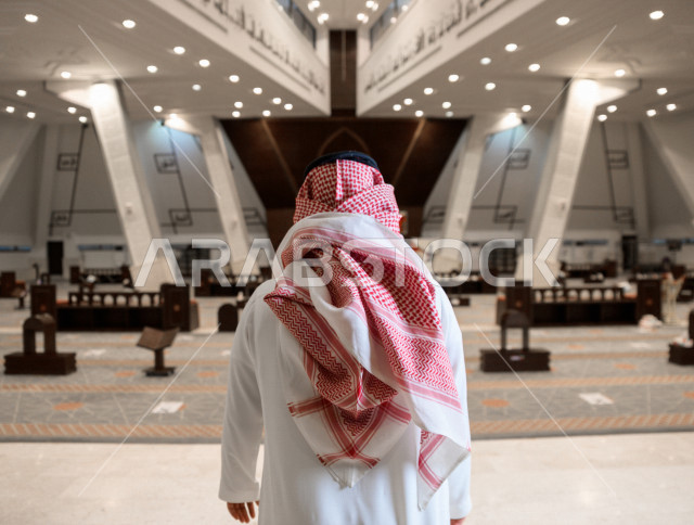 A Saudi Arabian Gulf Muslim man inside a mosque in the Kingdom of Saudi Arabia, performs his rituals in the mosque, worship and draw close to God