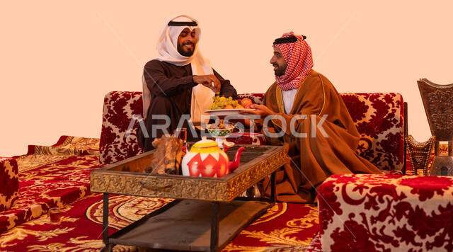 The spirit of bonding between community members on wild outings, hospitality and generosity in Saudi society, a portrait of a Saudi Gulf Arab man carrying out the duty of hospitality, traditional Saudi outdoor sessions, enjoying the local heritage and culture, a beige background