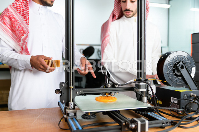 Two innovative young Saudis use a 3D printer to manufacture a product, innovation and engineering industries, a science, technology, engineering and mathematics academy