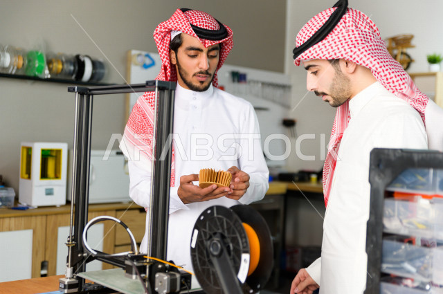 Two innovative young Saudis use a 3D printer to manufacture a product, innovation and engineering industries, a science, technology, engineering and mathematics academy
