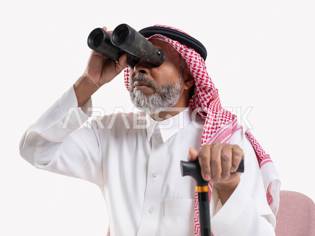 Using binocular telescopes to see distant objects, close-up portrait of an elderly Saudi Arabian Gulf man wearing a traditional thobe and shemagh looking at something, love of exploration and adventure, dream of achieving future goals and ambitions, white background