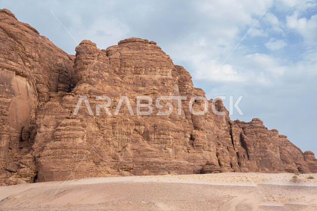 Stone formations and formations in the Kingdom of Saudi Arabia, desert nature in famous archaeological tourist sites, natural rock structure in the Al-Ula region, view of the sky filled with white clouds