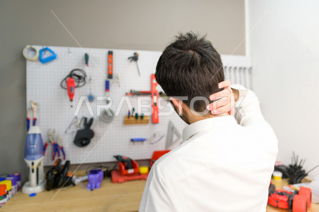 An innovative Saudi young man checks tools and equipment in the laboratory, using artificial intelligence for manufacturing, an academy specializing in science, technology, engineering and mathematics