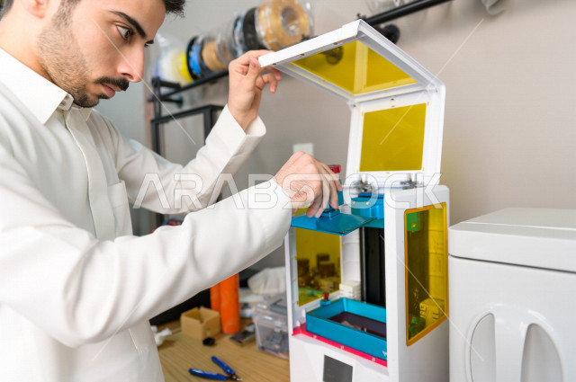 An innovative Saudi young man checks tools and equipment in the laboratory, using artificial intelligence for manufacturing, an academy specializing in science, technology, engineering and mathematics