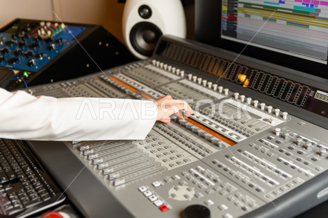 شاب سعودي يعمل كمرسال خارج الاستديو ،يعالج الاصوات المسجلة داخل الاستديو عن طريق برمجيات صوتية من خلال جهاز الحاسوب المخصص ، استديو تسجيل صوتي ، بث مباشر ، فريق الاعداد ، الاذاعة الصوتية ، نشرات اخبارية