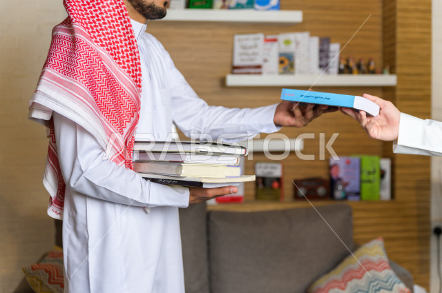 شابان سعوديان مثقفان يقضيان وقتهما في المكتبة و يقرأن الكتب ، قراءه كتب ،  الدراسة في المكتبة