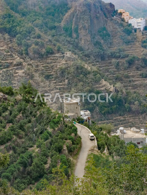 The mountain road in Faifa Governorate in the Kingdom of Saudi Arabia, agricultural terraces on the mountain peaks and heights in the city of Jazan, trees and green plants on the slopes of the mountains, famous tourist places and landmarks, enjoying the natural scenery and spending a pleasant and quiet time.