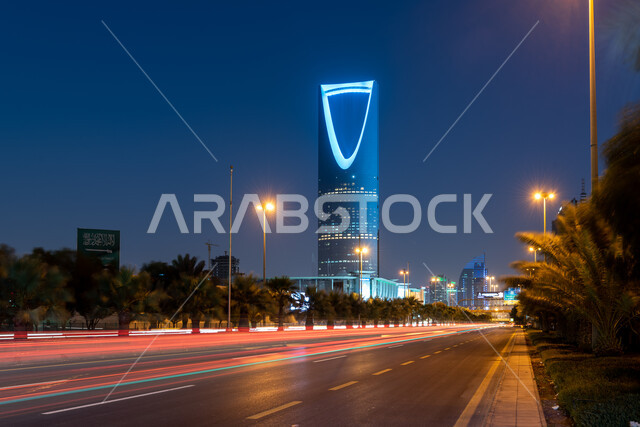 Residential buildings and streets in the capital, attracting foreign tourists to the famous landmarks and tourist places in Saudi Arabia, the architectural art of the illuminated Kingdom Tower in the city of Riyadh at night, the advanced and modern design of towers and skyscrapers.
