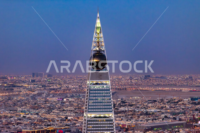 Work on the development and development of towers and buildings, architectural engineering art for facilities and skyscrapers, a close-up of the illuminated Al-Faisaliah Tower building at sunset in Saudi Arabia, famous tourist places and landmarks, the streets of the city of Riyadh