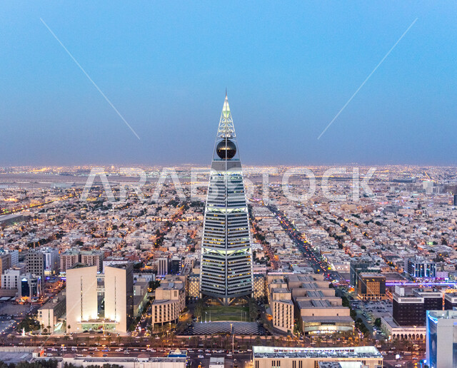 Population density and crowding in the city of Riyadh, work to develop towers and buildings, architectural engineering art for facilities and skyscrapers, a close-up of the illuminated Al-Faisaliah Tower building at sunset in Saudi Arabia, famous tourist places and landmarks