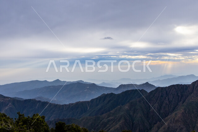 Tranquility and peace in the peaks and highlands, sunset moments over the Soudah Mountains in the Asir region, southwest of the Kingdom of Saudi Arabia, a stunning view of the cloudy sky, famous tourist places and attractions.