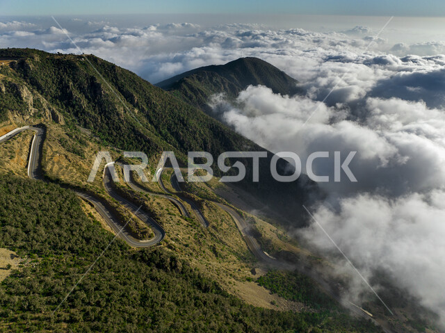 الجبال المغطاة بالسحب البيضاء في المملكة العربية السعودية, الطريق الجبلي الملتوي في جبال الهدا بمدينة الطائف, المناظر الطبيعية للقمم والمرتفعات الصخرية, الاستمتاع بالرحلات السياحية والأماكن والمعالم المشهورة
