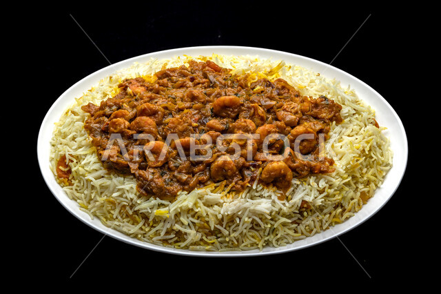 A plate of white rice with spiced shrimp, biryani rice with prawns, dishes from popular traditional Arabic cuisine, delicious healthy food recipes, Saudi cuisine meals, Bukhari rice with seafood, black background