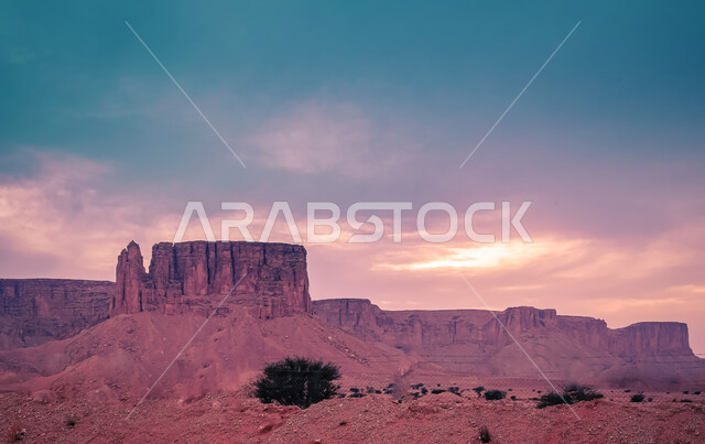 The Tuwaiq mountain range in Najd at sunset, the rocky edge of the apocalypse in the Riyadh desert in the Kingdom of Saudi Arabia, famous natural archaeological tourist attractions, desert nature and mountainous terrain in Saudi Arabia.