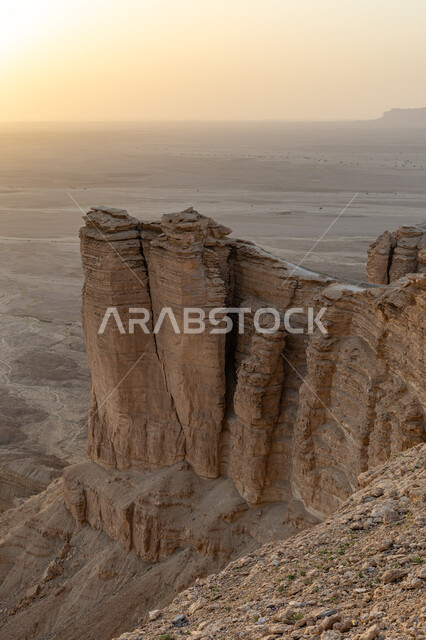 The Tuwaiq mountain range in Najd at sunset, the rocky edge of the apocalypse in the Riyadh desert in the Kingdom of Saudi Arabia, famous natural archaeological tourist attractions, desert nature and mountainous terrain in Saudi Arabia.