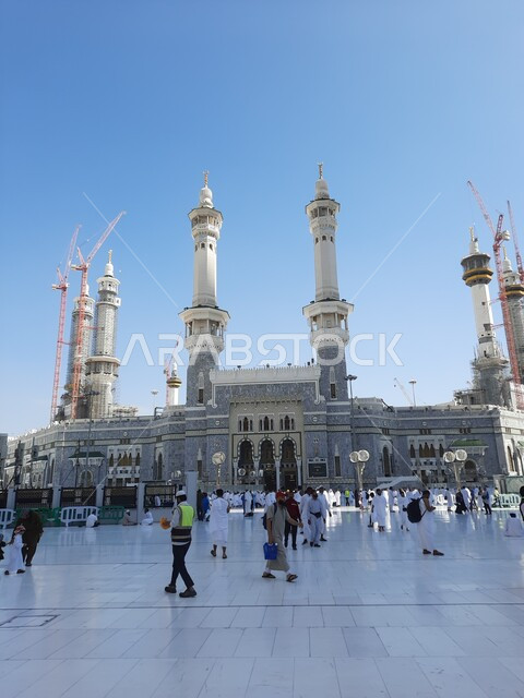 Pilgrims of the Holy House of God in the outer courtyard of the Grand Mosque in Mecca, sacred Islamic spiritual places and areas in the Kingdom of Saudi Arabia, architectural art in religious monuments, performing Hajj and Umrah rituals, worship and getting closer to God, Islamic matters and worship