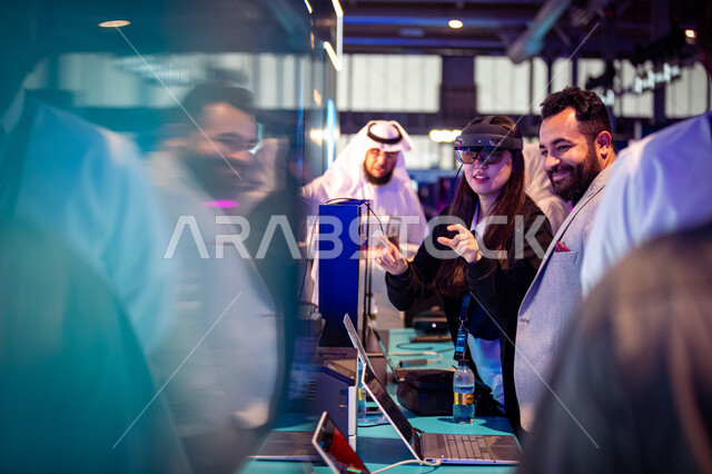 Exploring technologies in the field of cybersecurity, visitors from different countries coming to do an exciting, advanced experience at the Black Hat Cybersecurity Exhibition, achieving the goals of the Kingdom’s Vision 2030, wearing 3D glasses and trying to click on an element, Riyadh Season activities.