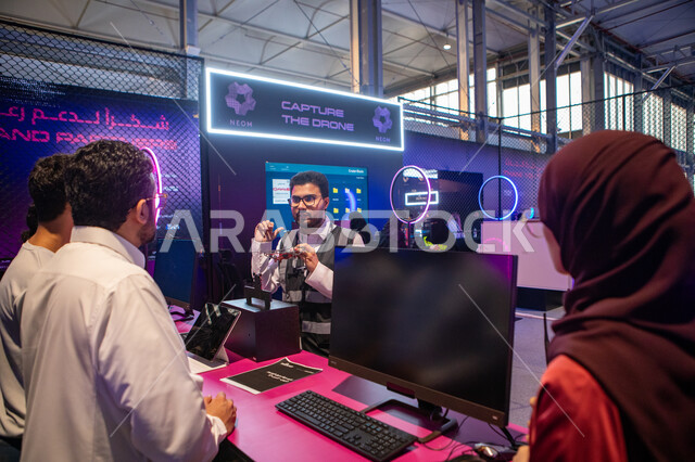 Providing information to visitors and ways to protect against information piracy and illegal penetration, creating a vital center to share the latest developments in network security, exploring innovations in the field of cybersecurity, Riyadh Season activities, a group of people at the Black Hat Cybersecurity Exhibition
