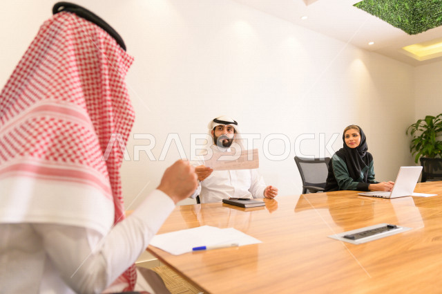 Administrative meeting with a group of Saudi Gulf people in the conference room, meeting of businessmen and a businesswoman together inside the company, a Saudi company, Gulf work, work team