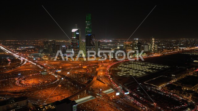 إضاءه أبراج الملك عبد الله المالية في وقت الليل أثناء الاحتفال في مناسبة الفوز في معرض اكسبو 2030 في السعودية، التطور و النمو الاقتصادي للابراج وناطحات السحاب, عروض ثقافية و أنشطه ترفيهية، صورة من الاعلى للفن الهندسي المعماري على الطراز الحديث