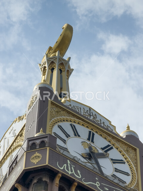 النمو والتقدم العمراني للأبراج وناطحات السحاب، الفن الهندسي المعماري للمناطق المقدسة، صورة مقربة لمبنى برج الساعة الملكي في مكة المكرمة, أماكن ومعالم إسلامية مشهورة في المملكة العربية السعودية، خلفية السماء المليئة بالغيوم البيضاء