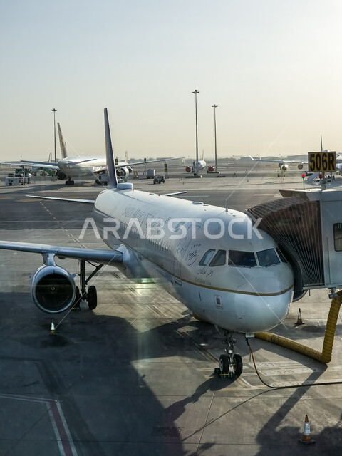 The concept of tourism and travel, a close-up of a plane standing at Khalid International Airport in Riyadh, Saudi airlines and companies, means of transportation and air transportation, providing advanced services for easy movement between countries