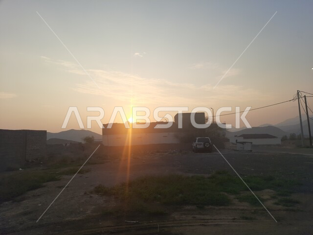 Mountain ranges and transportation routes at sunset, the rocky nature of the mountains of the Kingdom of Saudi Arabia, the terrain in the mountain peaks, the natural rock formations and formations of the high areas, famous tourist attractions in the city of Al-Hajra in the Al-Bahah region