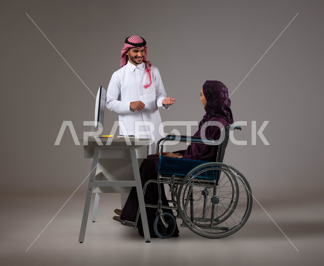 النقاش وتبادل الافكار والخبرات لتحقيق اهداف الشركة، تمكين اصحاب الهمم وذوي الاحتياجات الخاصة من الدخول الى مجال العمل، بورتريه لزميلين عربيين خليجيين سعوديين يقومان بإنجاز المهام عبر الحاسوب المحمول داخل المكتب، دمج العمل مع التقنية والتكنولوجيا، خلفية رمادية