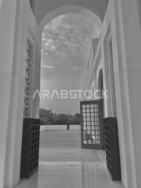 Sacred Islamic places, architectural arts in the distinctive Islamic style, a black and white picture of the gate of the Grand Mosque of Sultan Qaboos in the Sultanate of Oman, a call to Muslims to pray, worship, and draw closer to God, famous religious landmarks in Muscat