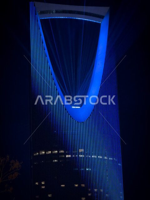 A close-up of the colorful lighting displays on the Kingdom Tower, an artistic journey of creative light transformation, enjoying the forms of light arts, the Noor Saudi Arabia festival and event, the seasonal Riyadh Art Program initiative, annual celebrations and events.