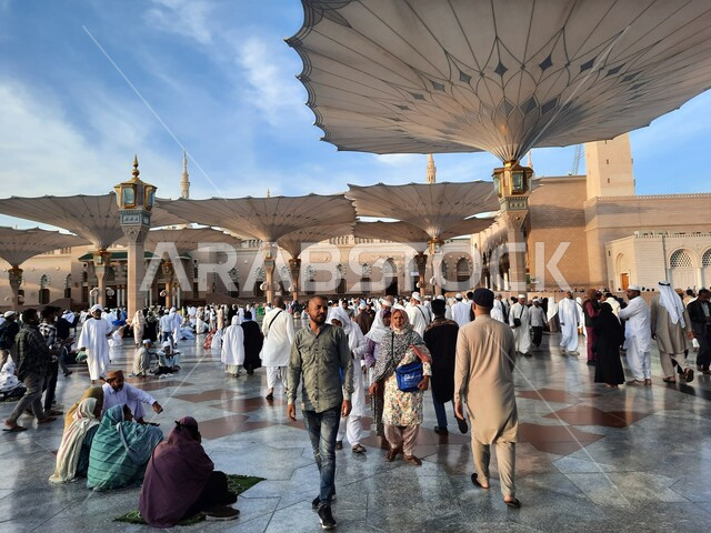 Islamic religious landmarks in the Kingdom, Muslims walking in the outer complex of the Prophet’s Mosque in Medina, electronic umbrellas in the Noble Prophet’s Mosque, worship and getting closer to God.