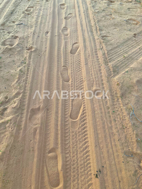 Distinctive recreational activities, a close-up of the effects of walking on golden sand in the middle of the desert in the Kingdom of Saudi Arabia, sand dunes and hills in the desert areas in the city of Qassim, famous tourist places