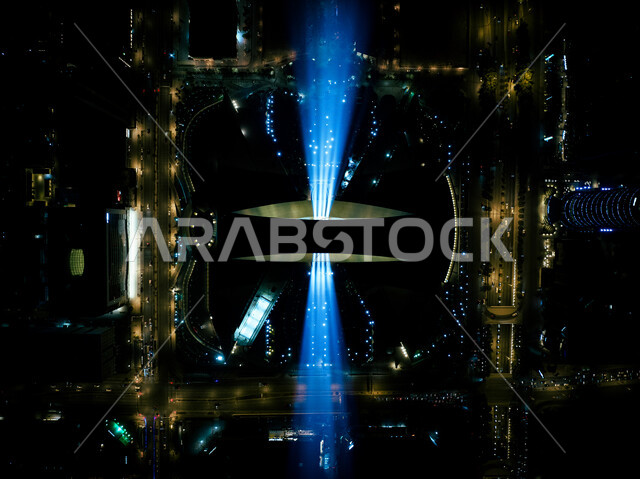 Riyadh Art seasonal program initiative, fun entertainment events and activities to attract tourists from abroad, annual celebrations and events, a vertical picture from above of the colorful lighting displays on the Kingdom Tower, an artistic trip for creative light transformation, the Saudi Noor Festival, enjoying the forms of light arts.