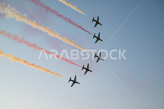 Air shows celebrating the anniversary of Saudi National Day, expressing love and loyalty to the country, national holidays and events, aviation exhibition activities for National Day on September 23, lines of colored smoke behind jet planes flying in the sky of the Kingdom, commemorating the founding day 1727 AD, Saudi Flag Day.