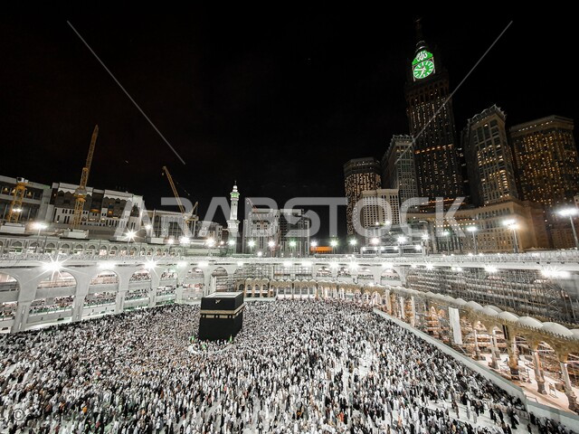 التقرب الى الله من خلال العبادة، حجاج بيت الله الحرام يطوفون حول الكعبة المشرفة في المساء، الاماكن المقدسة في المملكة العربية السعودية، الوحدة والتلاحم بين المسلمين، عكس الثقافة والتاريخ الاسلامي، تعزيز الروحانية والاستقرار النفسي