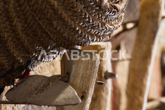 Traditional equipment made of burlap in the Kingdom of Saudi Arabia, the use of wicker palm fronds in home industry, authenticity and Saudi heritage. Old tools with an old folk style