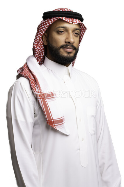Meditation, thinking and abandonment, the concept of elegance and masculinity, gestures of pleasure and self-confidence, a close-up portrait of a smiling Saudi Gulf Arab young man wearing a shemagh and traditional dress, standing straight looking at something, taking care and attention to his external appearance, a white background
