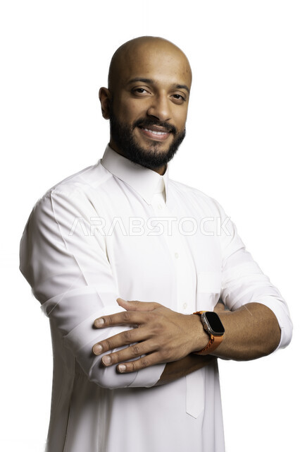 The concept of elegance and masculinity, attention and care for one’s external appearance, taking personal photos for official documents, a close-up portrait of a smiling, bald Saudi Arabian Gulf man wearing a traditional dress and a wristwatch, looking at the camera with expressions of pleasure and self-confidence, a white background