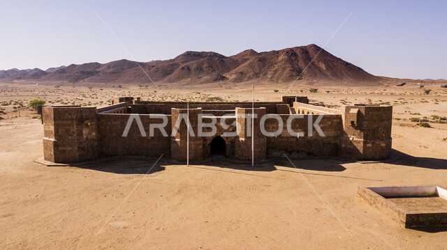 Ancient archaeological castles in the Tabuk region, rock formations and formations in the Arabian Desert, mountain peaks and heights in the wilderness areas, an overhead aerial photo of Al-Aznam Castle in Duba Governorate in broad daylight, tourist natural places in the Kingdom of Saudi Arabia.