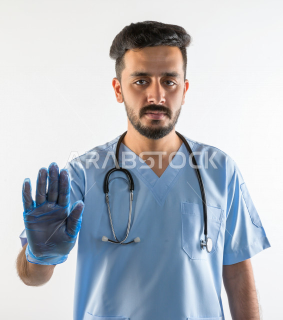 Portrait of a Saudi Gulf doctor smiling and looking at the camera, providing his services to patients efficiently, white background, medical and healthcare concept