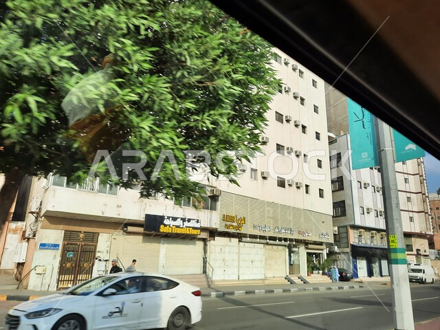 Interest in planting trees and green plants in Mecca, Prince Muhammad bin Salman bin Abdulaziz Road, sacred Islamic religious landmarks and places, car traffic on paved roads and streets in the Kingdom of Saudi Arabia, luxury hotels and towers surrounding the Grand Mosque