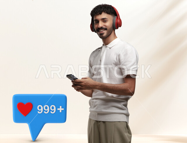 Using audio programs on the mobile phone, listening to songs using the headphone, portrait of a smiling Saudi Gulf Arab young man wearing a casual outfit, wearing a headset, looking at the camera with happy gestures, 3D message icon, white background