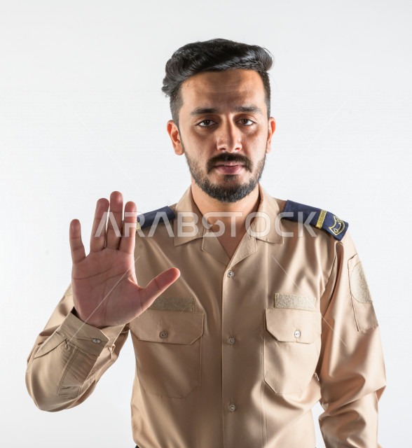 Portrait of a Saudi Arabian Gulf man working as a security man, wearing uniforms to work, maintaining security and reassurance, guard and safety, white background