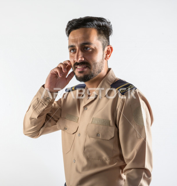 Portrait of a Saudi Arabian Gulf man working as a security man, wearing uniforms to work, maintaining security and reassurance, guard and safety, white background