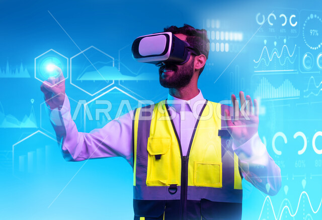 Working in the engineering sector through virtual reality technology, interacting with virtual engineering, a close-up portrait of a Saudi Gulf Arab engineer wearing a work jacket and VR glasses interacting with holographic indicators and engineering graphic lines, the growth of the technological engineering field, a blue background